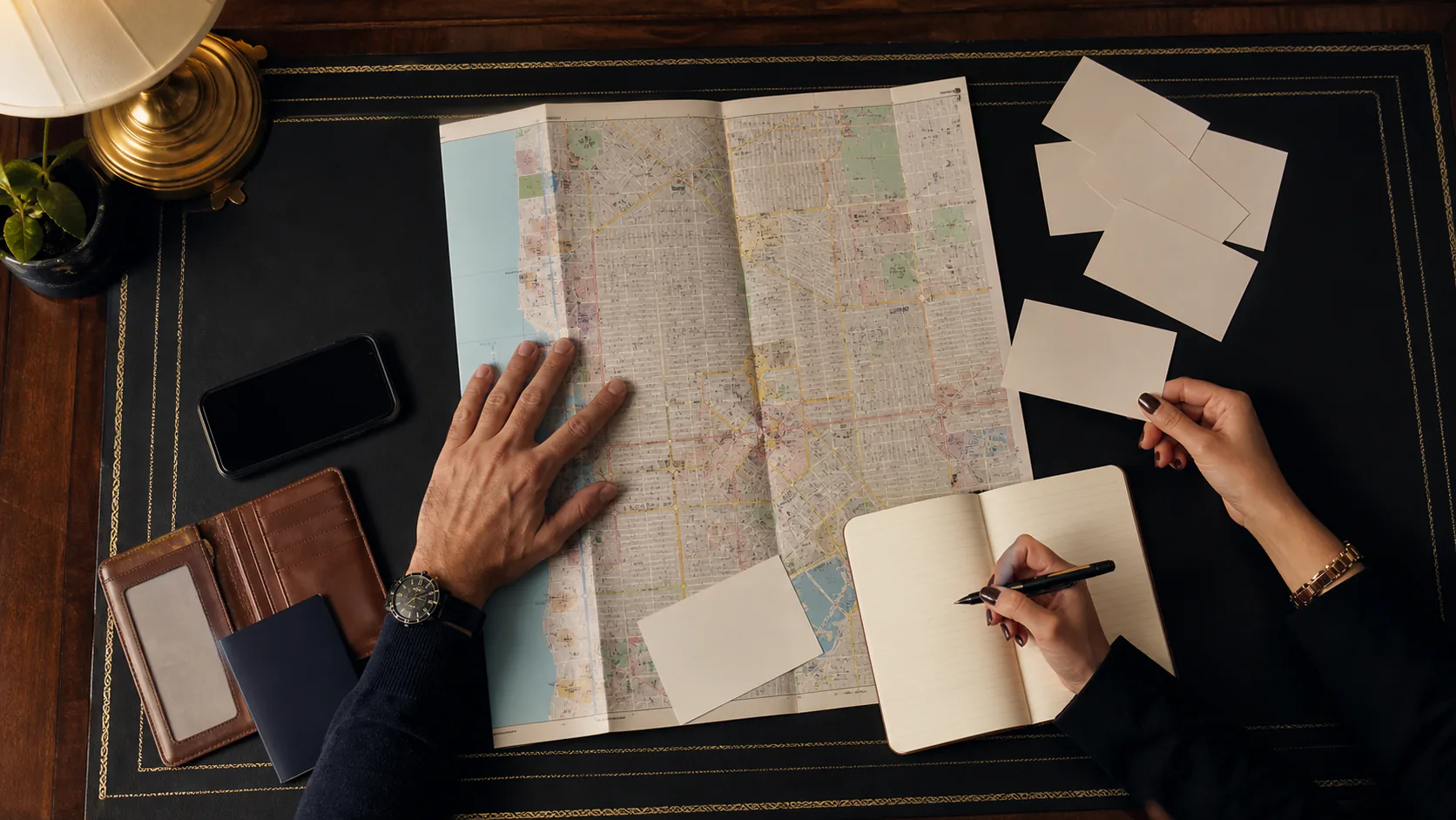 Hands organizing an unlabeled Las Vegas map and planning cards